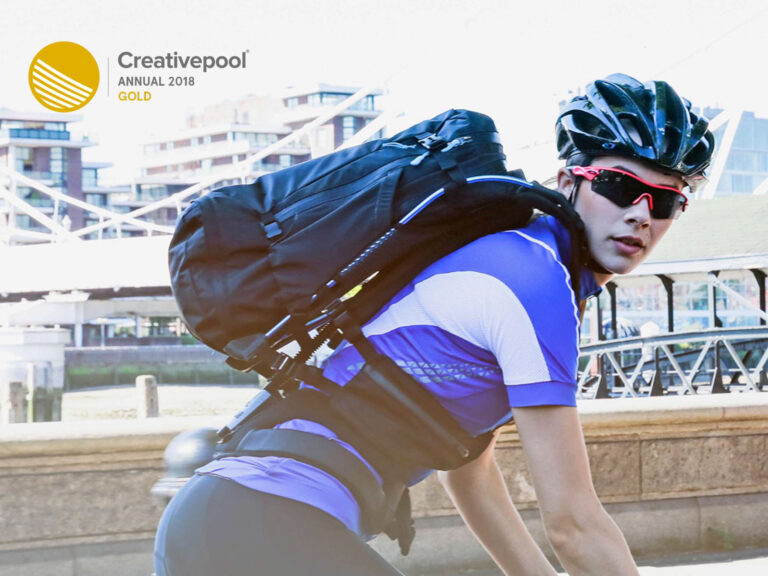 Cyclist using motionlab bag, logo of award won in the corner